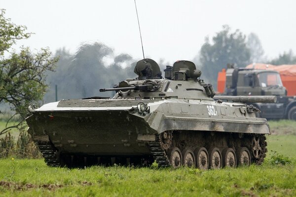 A combat vehicle is driving across the field