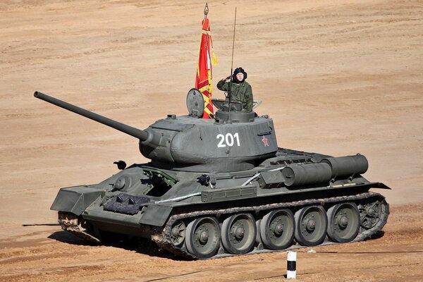 A tank with a soldier rides through the landfill