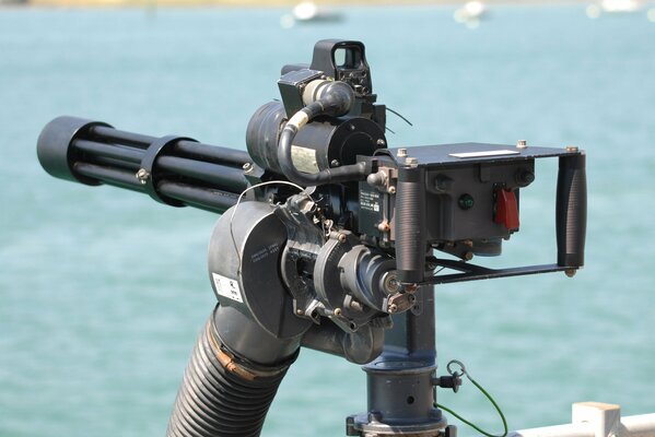 Multi-barrel machine gun m 134 on the background of the sea