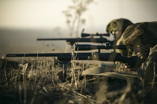 Snipers with sniper rifles with optical sight