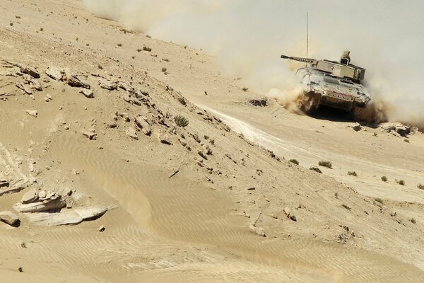 A tank passing through a sandy desert