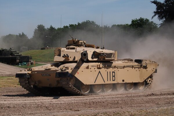 Tracked tank rides on the ground