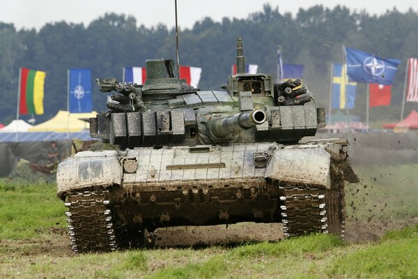 A battle tank rides across the field