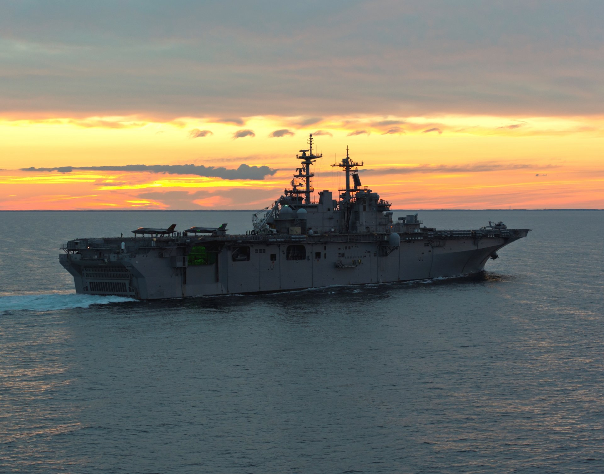 ea night sunset uss wasp lhd1 amphibious assault ship deck f-35b lightning ii fighters swimming wake