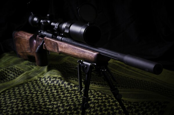 Sniper rifle lying on the fabric