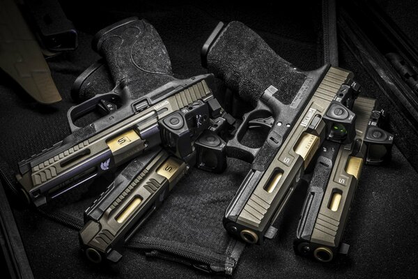 Four pistols lying on a black cloth