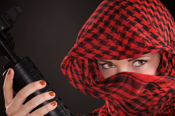 A girl in a red scarf with a gun