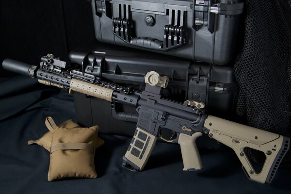 Composition of a rifle and boxes on a dark background