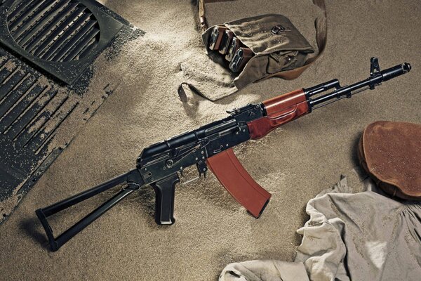 Kalashnikov assault rifle lying on the sand