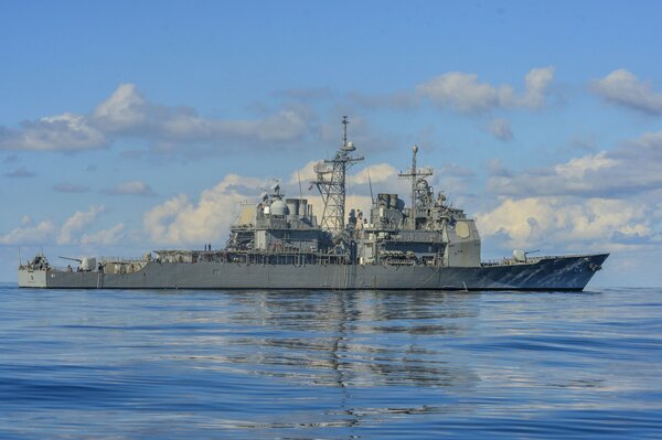 Cruiser at sea against the background of clouds