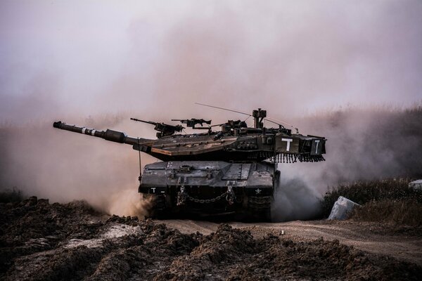 A battle tank that raises dirt and dust