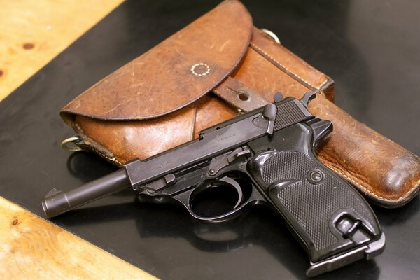 Still life of a pistol and holster on a black background