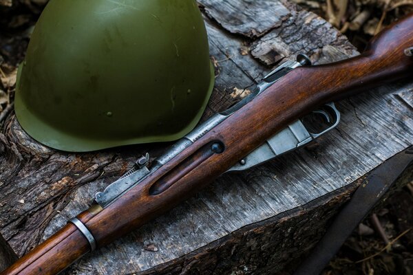 Mosin s rifle and helmet lying on the table