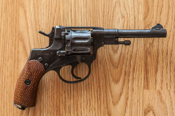 Revolver on the background of a wooden board