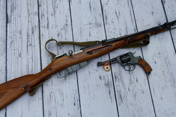 Rifle and revolver with badge