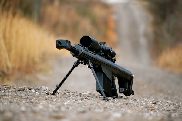 Barrett M82 large-caliber sniper rifle gravel