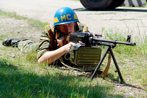 A soldier of the Russian peacekeeping contingent lying on the ground