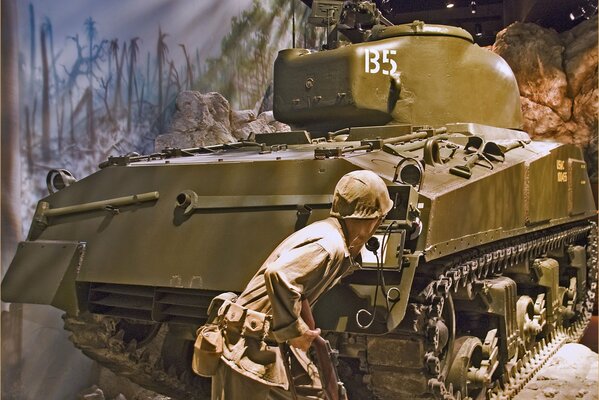 A soldier near a tank during the war