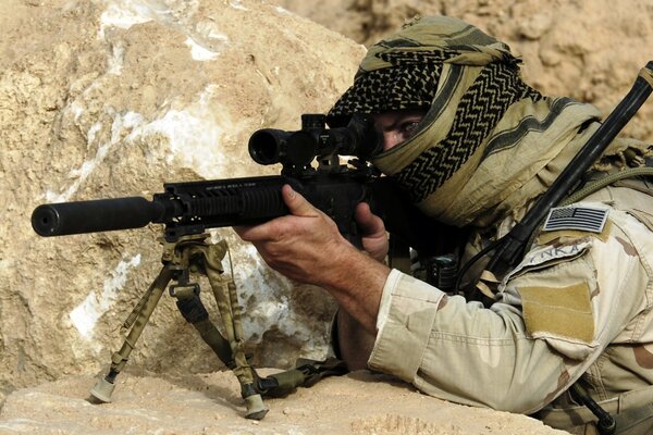 A US Army soldier takes aim