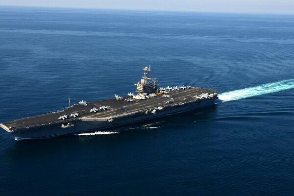 The aircraft carrier is sailing in the open sea