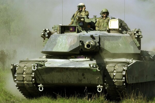 Two soldiers are sitting on the tank