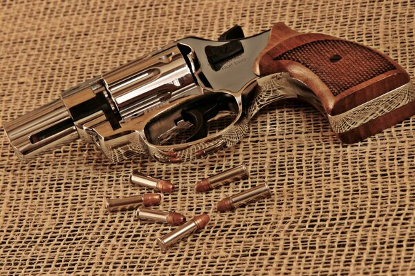 Photo of a gun next to bullets