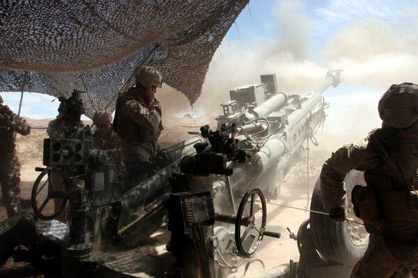 Soldiers in uniform with a cannon