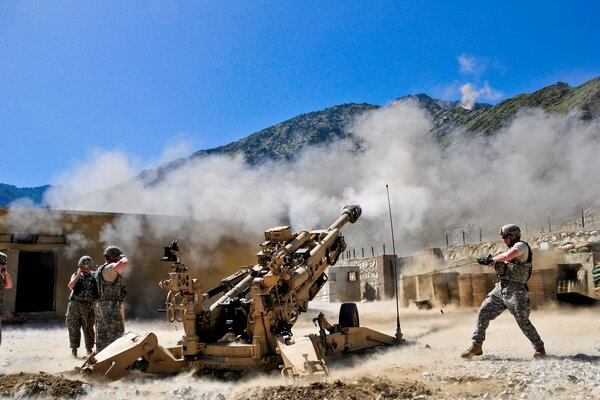 Soldiers at war with a howitzer and weapons