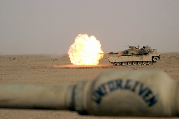 A shot of fire from a tank in the desert