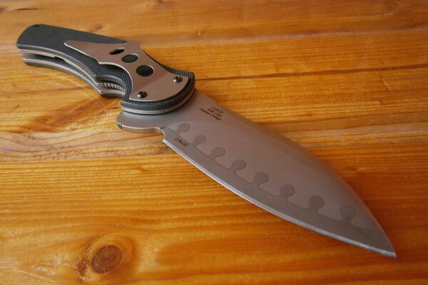 Folding knife on a wooden table