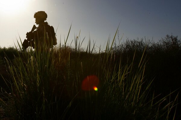 Profile of an armed soldier at sunset