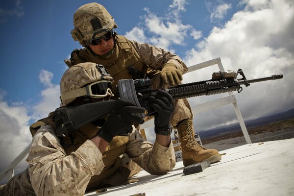 Soldiers with automatic rifles at a combat post