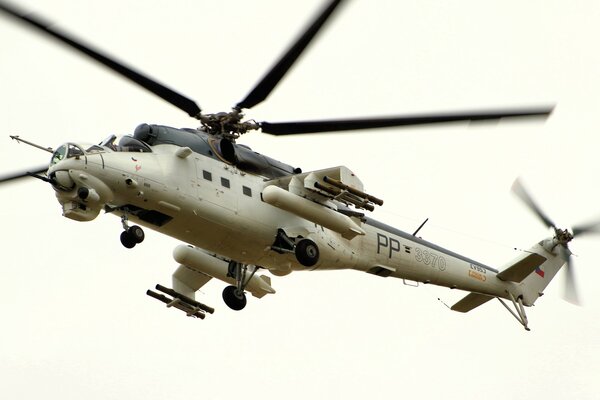 Mi-24 helicopter in flight on a white background