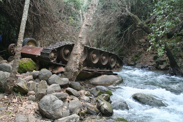 An inverted tank in the water at a waterfall