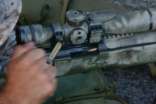 Shot from a rifle with a sight, bolt and sleeve