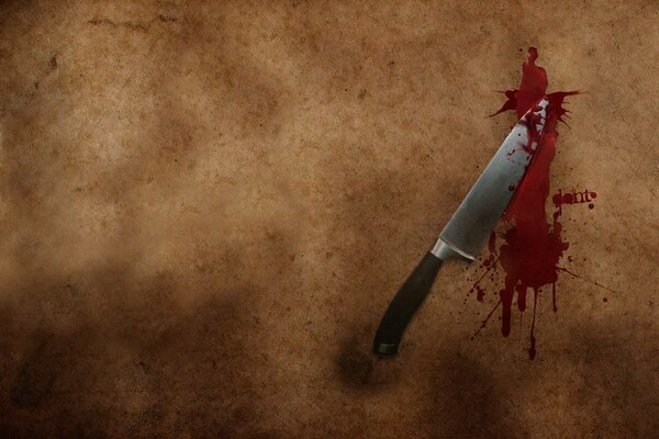 A bloody knife on a simple background