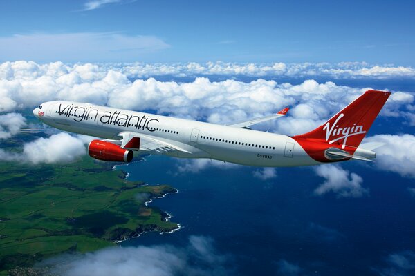 Passagierflugzeug auf dem Hintergrund von Wolken und Meer