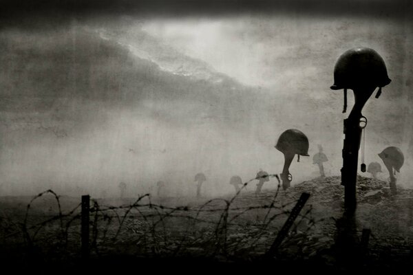 The theme of war. Helmet, rifle, cemetery