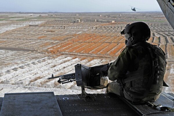 Overview of the field by a soldier with a weapon