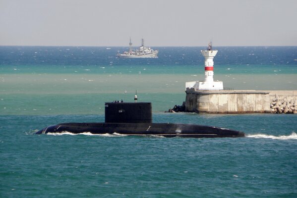 Submarine at sea, with a lighthouse