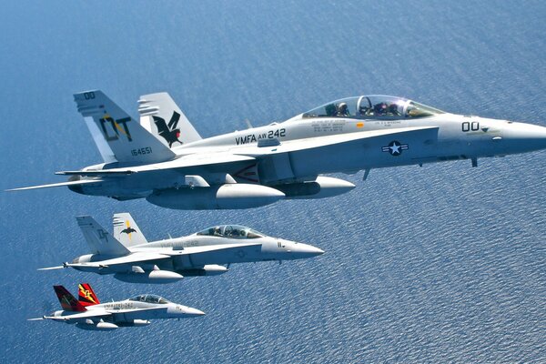 Carrier-based fighters in flight over the sea