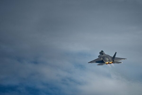 The F - 22 raptor multirole fighter is flying in the sky