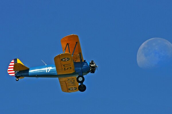 American plane on the background of the daytime moon