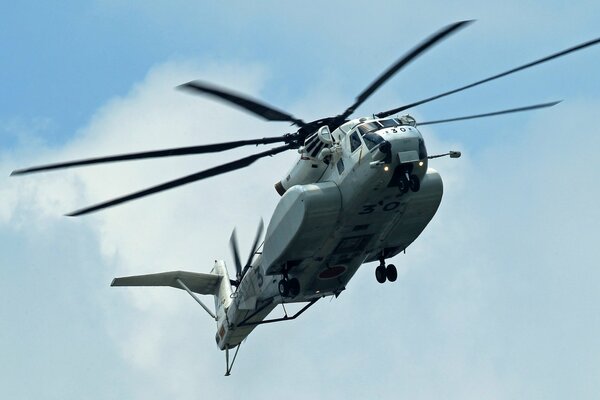 Flying helicopter on the background of the sky with debris