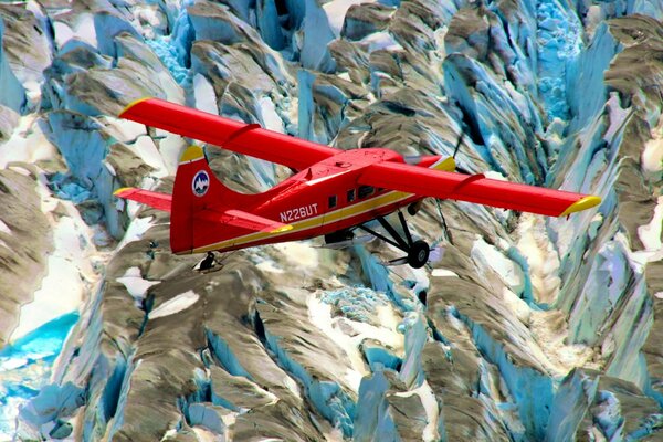 Red plane over snowy mountains