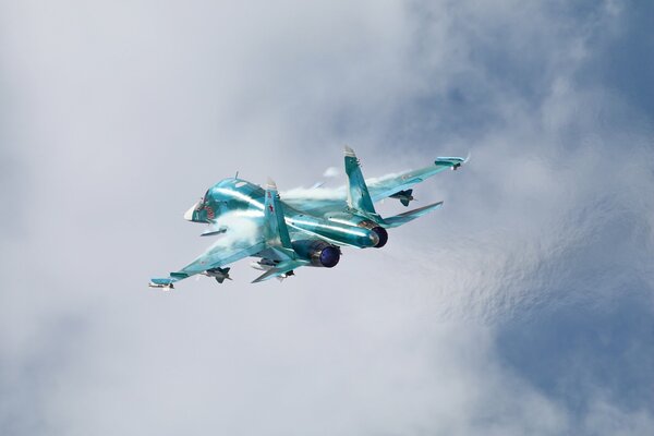 The Russian Su-34 fighter-bomber is flying in the clouds
