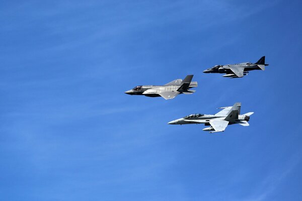 Three av-8 planes fly through the sky