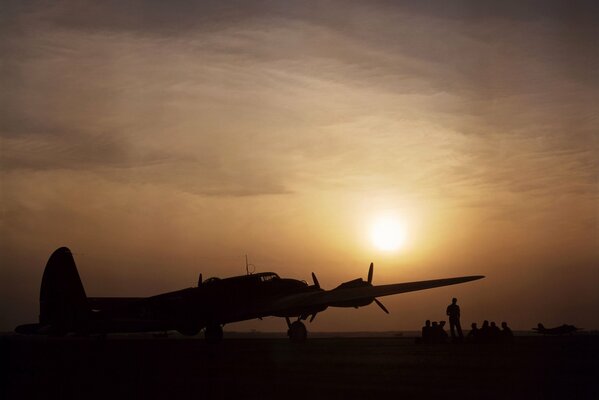 A group of people at sunset at the plane