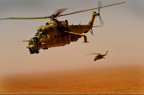 Two flying helicopters on a desert background