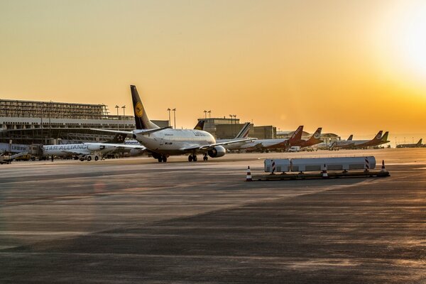 Boeing passenger plane at the airfield at sunset